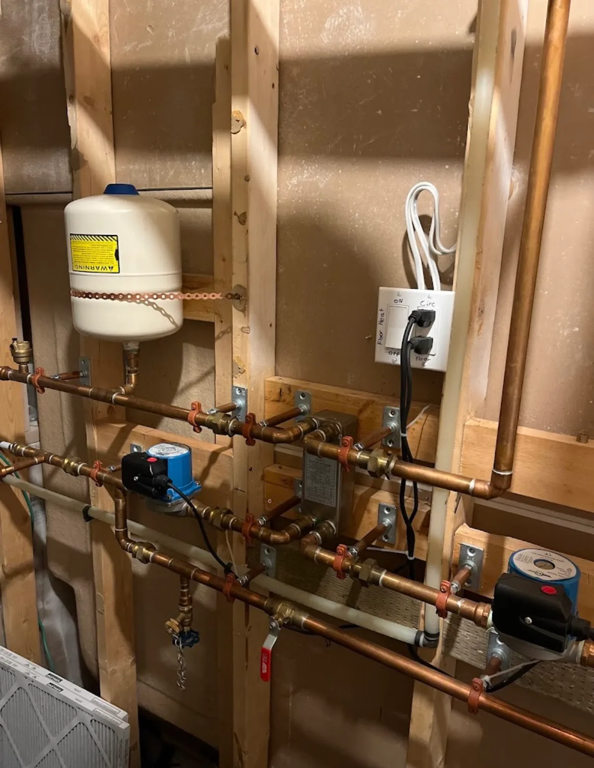 In-floor heat manifold and circulation control panel installed by First Class Mechanical