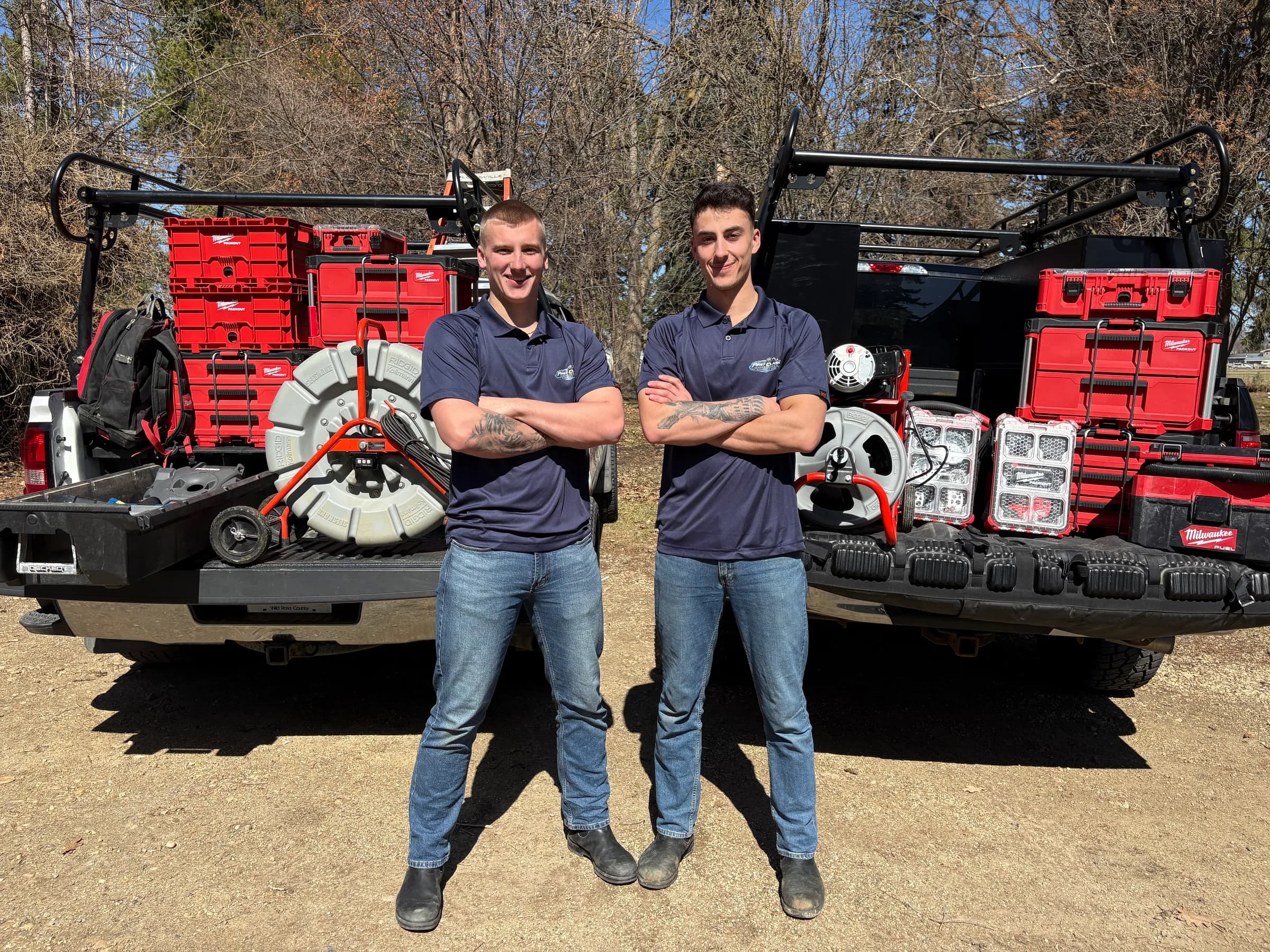 Two First Class Mechanical Red Seal plumbing and heating technicians standing in front of a fully stocked service truck in Central Alberta