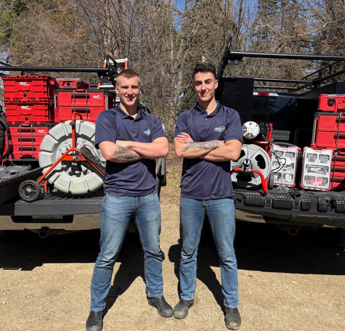 First Class Mechanical technicians with drain cleaning equipment and tool storage in the service truck bed